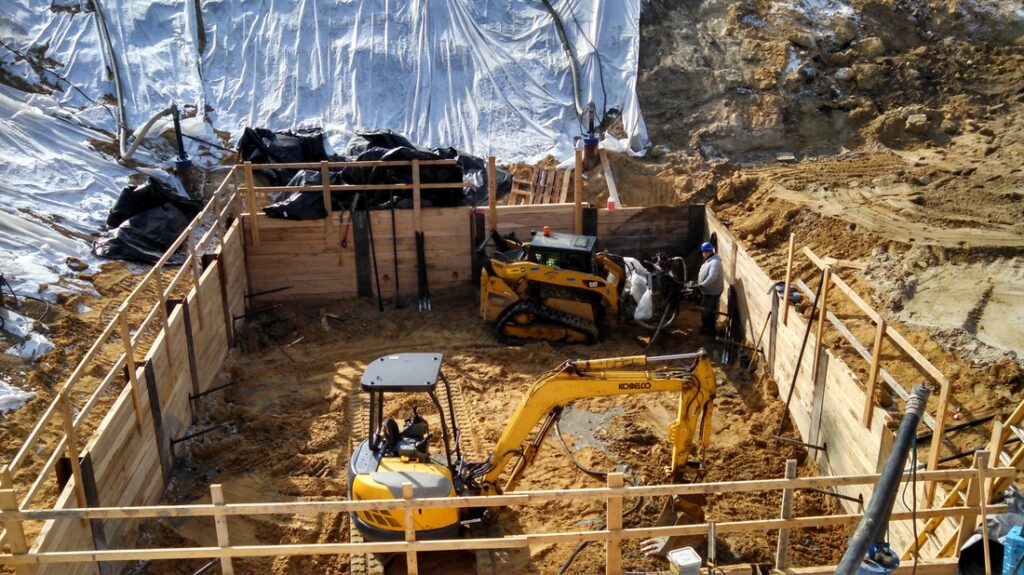 Excavation with shoring and small equipment working inside a supported pit